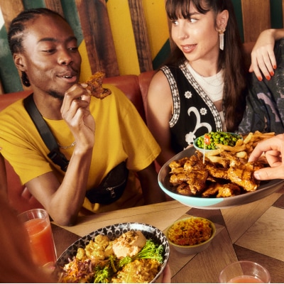 Friends sharing Nando's chicken wings